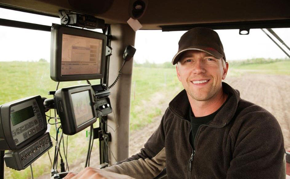 Farmer in tractor cab with computer monitors