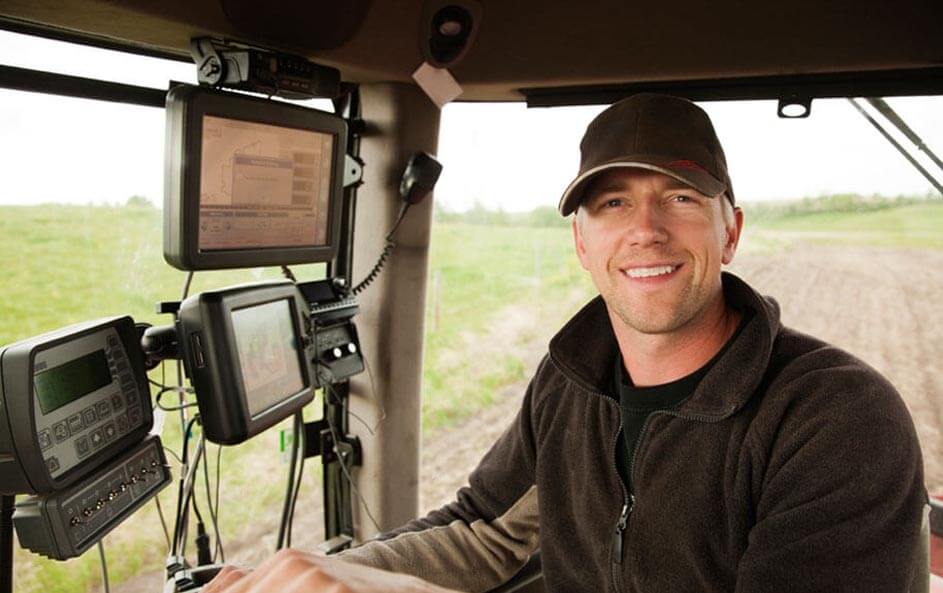 Farmer in tractor cab with computer monitors