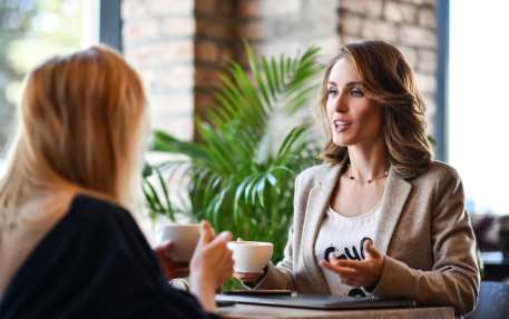 Two women drinking coffee